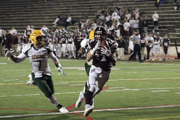 Mercer Island wide receiver Jack Counihan gallops into the end zone after hauling in a 43-yard touchdown pass from quarterback Alfonso Gonzalez during Mercer Island's football game against Sehome Friday at Islander Stadium. The Islanders beat the Mariners