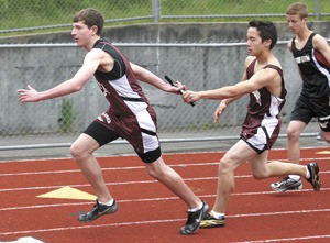 Island Middle School student Ethan Vu hands off to Peter Welch during the 2010 Foothills finals meet on June 1 at Liberty High School.