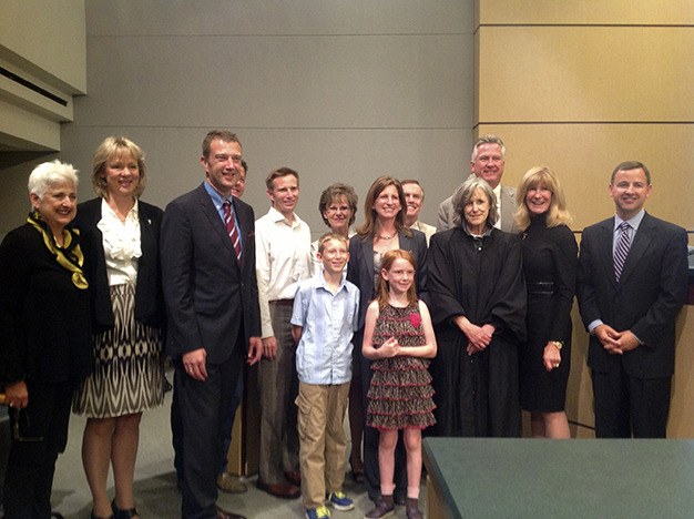 Tana Senn joins her family and King County Council members after being sworn in as the new 41st District representative on Monday