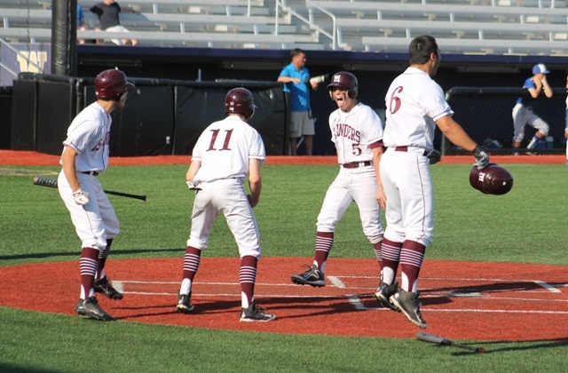 Mercer Island's Josh Stenberg (5) celebrates with teammates Michael Bantle (11)