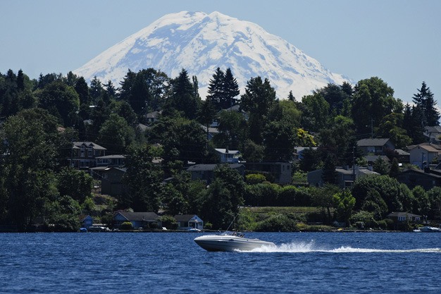 Boaters enjoy temperatures near 80 as Mount Rainier looms over Lake Washington in this view from Clarke Beach Park on Mercer Island on Tuesday