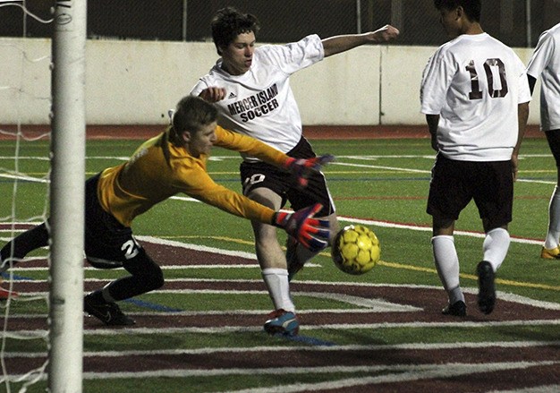 Mercer Island's Jamie Shannon shoots against Lake Washington goalkeeper Jamison Gunhus Friday