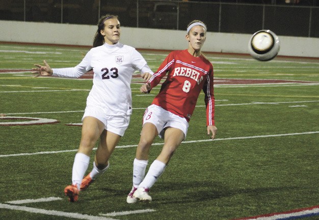 Juanita's Sam Bakory races to beat Mercer Island's Carly Ledbetter to the ball during the Islanders home win over the Rebels on Tuesday