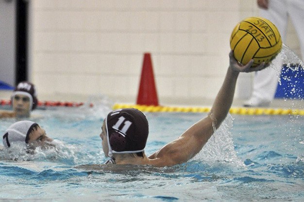 Mercer Island’s Ford Witman fends off his defender during the water polo state tournament.