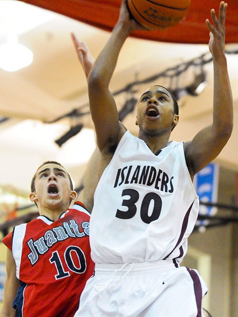 Islander Sloan Aikens (30) drives past Rebel Zac Brandon during opening round of Kingco 3A league tournament play at Mercer Island on Tuesday.