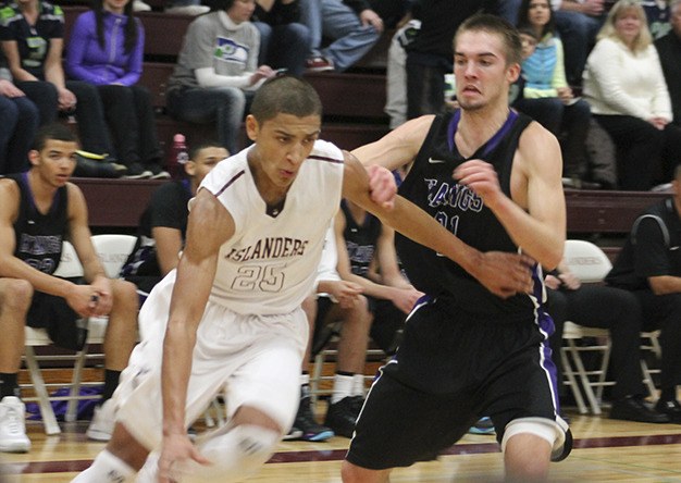 Mercer Island’s Kaleb Warner drives past Lake Washington’s Drew Heimdahl Friday