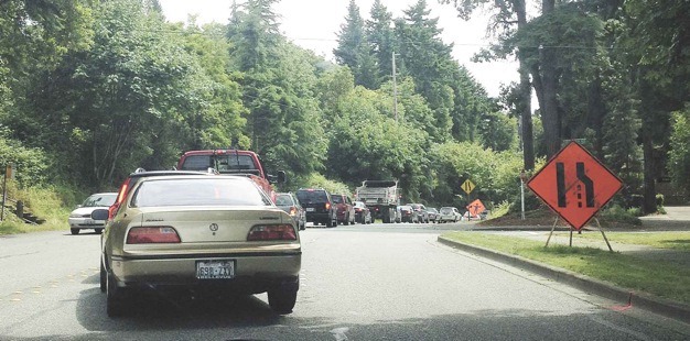 Island Crest Way traffic has been backed up as construction workers remove medians. Delays are expected to lessen as this project is complete.