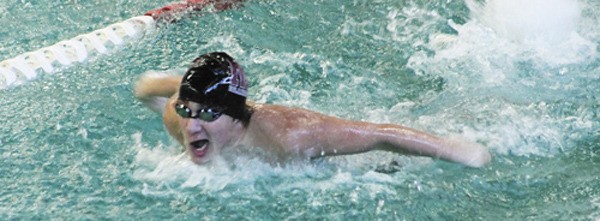 Nick Swaya swims the 100-yard butterfly event during the Mercer Island meet against Bellevue on Thursday