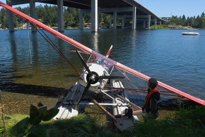 A small kit-type float plane is beached after suffering a structural collpase after landing on Lake Washington on the East side of Mercer Island on Wednesday. No injuries were reported and the disabled aircraft was towed to shore by a passing boater.