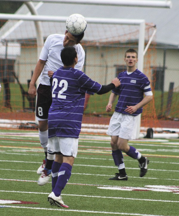 Mercer Island's David Lee (8) heads the ball past Lake Wasington's Ricardo Oprenza during the Islanders 1-0 playoff loss to the Kangs.