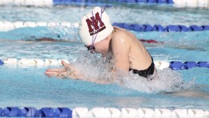 Julie Baker tackles the breaststroke leg of the 200 medley relay during the Islanders meet against Newport at the Beach Club on Tuesday