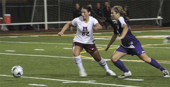 Islander Celina Solomon runs after a loose ball as Lake Washington’s Amy Johnson heads for it. The Islanders lost to the Kangs
