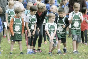 St. Monica cross country coach Leslie Lawrence readies some of her younger runners for competition at the CYO cross country championship meet on Oct. 9 at Lake Sammamish State Park.