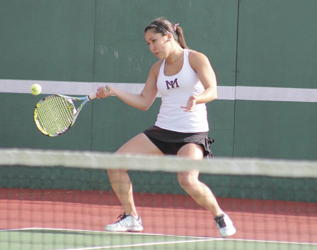 Mercer Island's Gabby Venditti returns a serve during her doubles match with twin sister Lydia against Sammamish on Tuesday