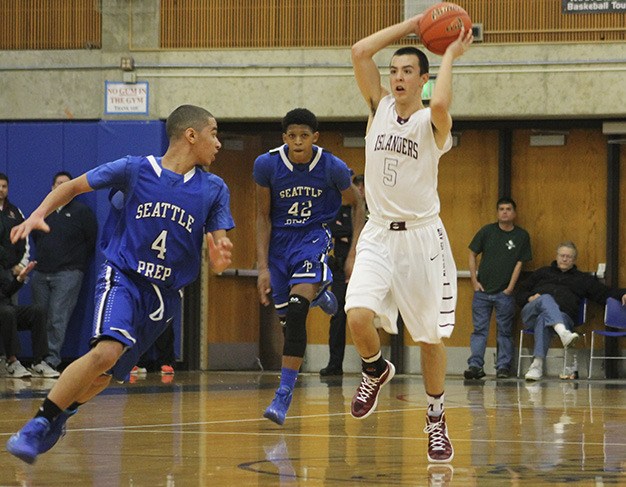 Mercer Island’s Chris Lawler looks to pass as he brings the ball upccourt against Seattle Prep Saturday
