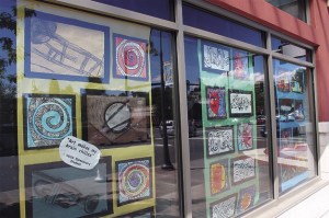 Drawings by Mercer Island students are exhibited in the windows of The Mercer building.