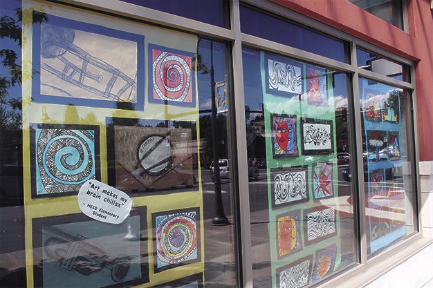Drawings by Mercer Island students are exhibited in the windows of The Mercer building.