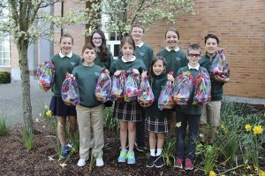 Seventh and third graders from St. Monica School are working on the school’s annual “Project Easter Basket” where students put together baskets for every student at a Seattle K - 8 school in need. Baskets include a toy