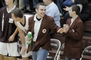 Mercer Island boys basketball team manager Matthew Sexton works with the team during the second half of the Islanders’ win over Lake Washington in early January. Sexton has been working as the team’s manager since he was in eighth grade.