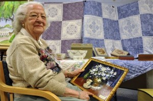 Nancy Mayes holds one of her oil paintings