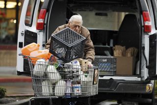 Chad Coleman/Mercer Island Reporter Islander Lou Borda picks up food donations for Friends of the Needy from Albertsons grocery on Mercer Island.