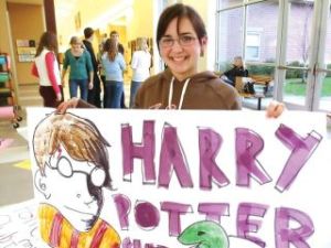 Mercer Island Reporter/File photo Islander Claire Goetschel holds a Harry Potter sign at Mercer Island High School. Goetschel was the headmaster of the Harry Potter Club at the high school.