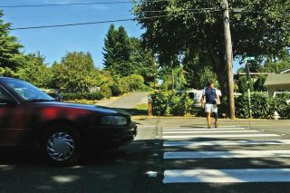 Julie Pena/Mercer Island Reporter file photo Island resident Steve Ybarra walks across Island Crest Way on a crosswalk located at the 4200 block in August 2005. A jury recently found the city negligent in a lawsuit brought forth by Ybarra. Jurors also assigned 54 percent of the blame for the accident on Ybarra.