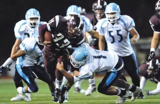Chad Coleman/Mercer Island Reporter Islander Peyton Bell attempts to run through the Interlake defense Friday night as Mercer Island lost its Homecoming game 28-21.