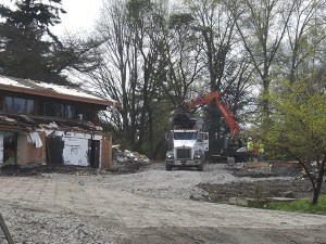 Demolition  work continues at  the Coval House in the 3000 block of 84th Avenue S.E. last Friday
