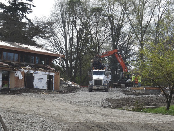 Demolition  work continues at  the Coval House in the 3000 block of 84th Avenue S.E. last Friday