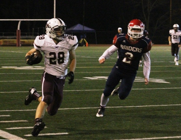 Mercer Island running back Jordano Mark dashes past Nathan Hale linebacker Teddy Cosgrove during their week 10 matchup Friday night at Nathan Hale High School. The Raiders beat the Islanders 33-28.