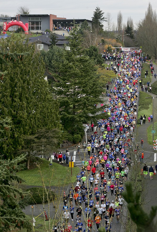 Racers in the 2015 Mercer Island Half Marathon make their way down North Mercer Way at the race’s start.