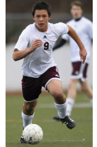 Islander Matt Johnson brings the ball up field for the unbeaten boys soccer team.