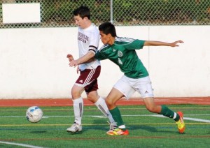 Mercer Island senior Alex Wood battles Mount Vernon's Efrain Lopez during the 3A state playoffs. The Islanders won 3-0 to advance to semifinals.