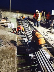 Crews replace part of one of the huge expansion joints on I-90 at the East Channel Bridge on Sunday morning.