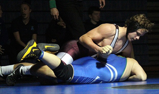 Mercer Island's Donnie Howard grapples with opponent Brendan Nguyen of Liberty in their 195 match Thursday