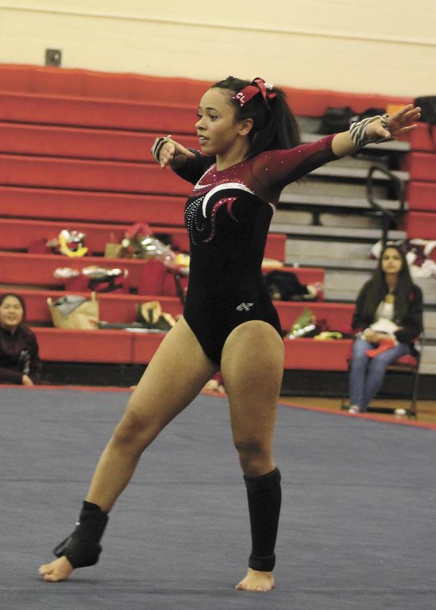 Cheyanne Lewis competes on the floor during the SeaKing district competition. She will compete in the floor at state this weekend.