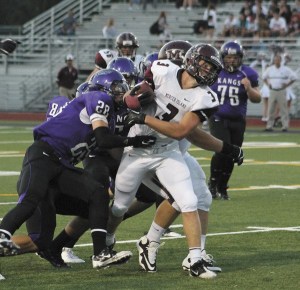 Mercer Island's Matt Orehek tries to pull free of the Lake Washington defense during the Islanders win over the Kangs on Friday