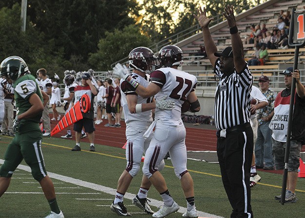 Mercer Island's Jack Counihan (22) celebrates his first-quarter touchdown with teammate Jack Vassau. Mercer Island beat Kentridge 44-10 Friday night at French Field.
