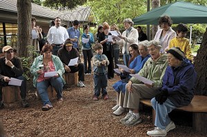 Community members gather at an opening celebration for a new community garden space at the Mercer Island Library. The garden was designed and built by community members under the guidance of Pomegranate Center