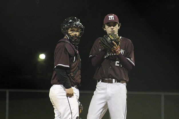 Mercer Island catcher Keegan Ogard confers with pitcher Aidan Plummer during the Islanders' KingCo opener against Lake Washington Friday