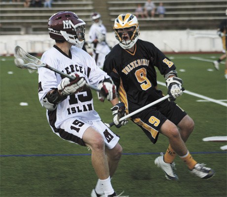 Mercer Island’s Alex Rorem (15) looks for an open teammate to pass to as  Bellevue’s Cole Nordstrom (9) plays defense during the Islanders’ 7-5 win over Bellevue last Friday.