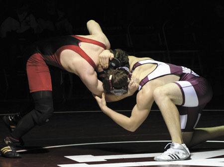 Mercer Island wrestler T.J. Blackburn looks to take down his Ballard opponent during the Islanders home win over the Beavers.