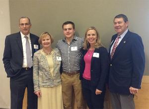 Brett Bottomley (center) smiles with Chamber officers Ralph Swanson and Emmett Maloof