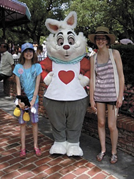 Megan and Rebecca Charney pose with the White Rabbit at Disney World. Megan Charney’s trip was courtesy of the Northwest chapter of the Make-A-Wish Foundation.