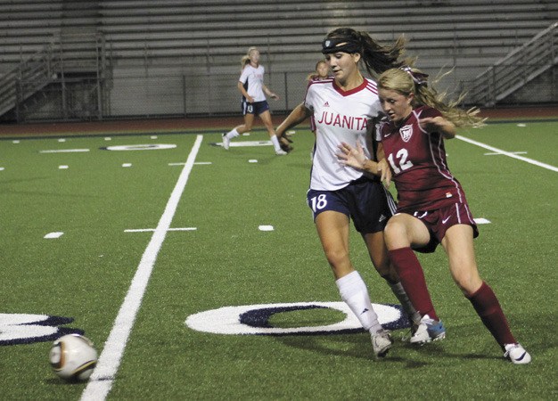 Mercer Island's Michele Day (12) tries to get to the ball at the same time as Juanita's Lauren McAlister on Thursday