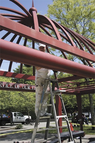 Matt Lundquist works on sanding the Veterans Memorial in Mercerdale Park on Friday afternoon. Lundquist works with Seattle Painting Specialists.