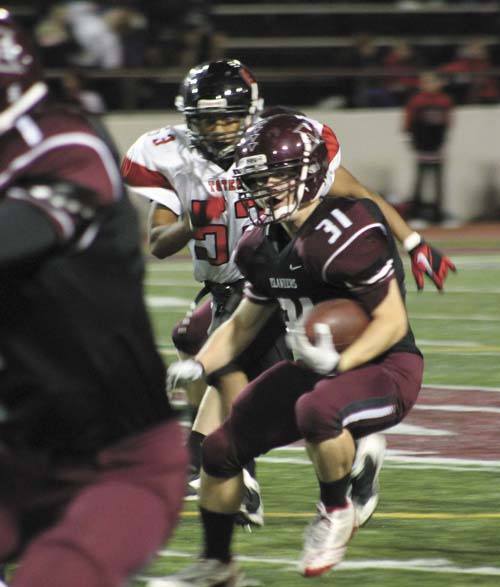 Mercer Island's Sam Gottlieb (31) looks for an open route as Sammamish's Paco Jacinto closes in from behind during the Islanders 45-6 win over the Totems last Friday.