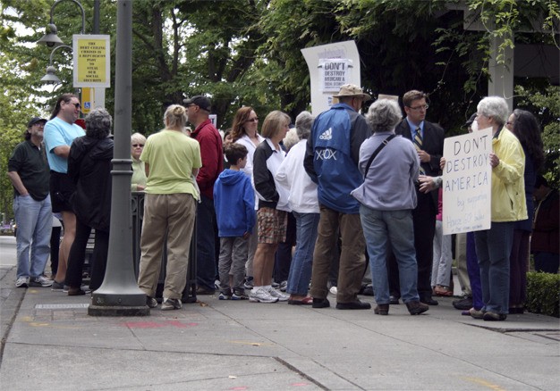 Eighth District constituents gather outside of U.S. Rep. Dave Reichert's office on Mercer Island