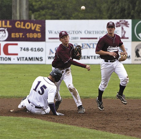 Mercer Island’s Kirby Ingram throws the ball to first base after getting a Sumner batter out. The Islanders won their first state game
